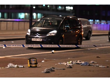 Debris and abandoned cars remain on London Bridge at the scene of an apparent terror attack.