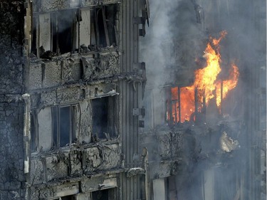 Smoke and flames billow from a massive fire that raged in a high-rise apartment building in London, Wednesday, June 14, 2017. Fire swept through a high-rise apartment building in west London early Wednesday, killing an unknown number of people and sending more than 50 people to area hospitals.
