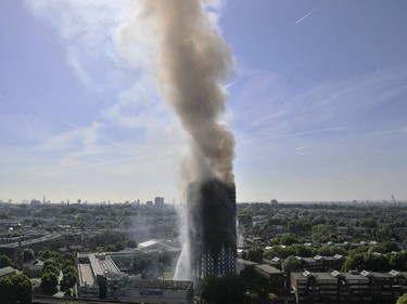 Smoke billows from a fire that has engulfed the 24-storey Grenfell Tower in west London, Wednesday June 14, 2017. Fire swept through a high-rise apartment building in west London early Wednesday, killing an unknown number of people with around 50 people being taken to hospital.