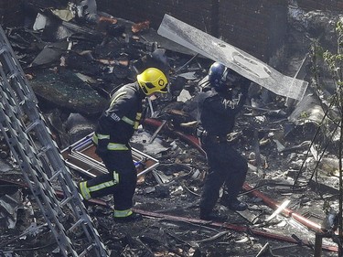 Firefighters battle a massive fire that raged in a 27-floor high-rise apartment building in London, Wednesday, June 14, 2017. Fire swept through a high-rise apartment building in west London early Wednesday, killing an unknown number of people and sending more than 50 people to area hospitals.