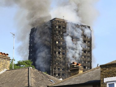 Smoke billows from from a high-rise apartment building on fire in London, Wednesday, June 14, 2017. A massive fire raced through the 27-story high-rise apartment building in west London early Wednesday, sending at least 30 people to hospitals, emergency officials said.