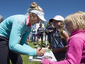 Brooke Henderson of Canada signs autographs for young fans during the Pro-Am at the LPGA Classic at Whistle Bear Golf Club in Cambridge, Ont. on Wednesday June 7, 2017.