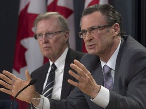 Senate Committee on Legal and Constitutional Affairs Chair Senator Bob Runciman listens as Senator George Baker responds to a question after releasing the committee's final report on court delays in Canada during a news conference in Ottawa, Wednesday June 14, 2017. THE CANADIAN PRESS/Adrian Wyld