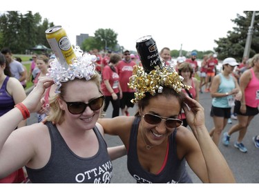 Ottawa craft beer enthusiasts descended on Lansdowne Park to partake in the 5K Ottawa Craft Beer Run along the Rideau Canal to raise funds for the Parkdale Food Centre, on Saturday, June 17. Erin Bartlett (left) made these custom craft beer hats that she and her friend Donna Chute sported for the race. (David Kawai)

126925
David Kawai