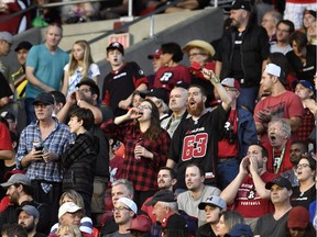 Fans react after Calgary Stampeders' Kamar Jorden, not shown, has his catch ruled a touchdown, nullifying an interception and touchdown by Ottawa Redblacks' Khalil Bass, not shown, during first period CFL action in Ottawa on Friday, June 23, 2017. Officials ruled the play a touchdown.