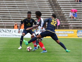 Fury FC's Michael Salazar finds himself surrounded by Bethlehem Steel FC's Marcus Epps, left, and Giliano Wijnaldum during Sunday's contest.