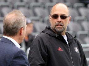 Redblacks general manager Marcel Desjardins, right, says Monday's roster moves were made based on "moving on" from players who would not have made the Redblacks roster in 2017. Julie Oliver/Postmedia