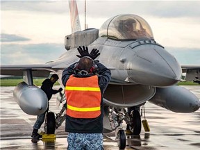 Ground crew from the Republic of Singapore Air Force, 425th Fighter Squadron marshal one of their F-16 Falcon fighters, during Exercise MAPLE FLAG 50, at 4 Wing Cold Lake, on June 9, 2017.
Photo: Cpl Justin Roy, 4 Wing Imaging, 
CK07-2017-0467-012