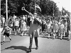 Bobby Gimby, the 'Pied Piper of Canada,' leads a group of children during a centennnial parade in 1967. (Courtesy of Library and Archives Canada)