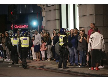 Guests from the Premier Inn Bankside Hotel are evacuated and kept in a group with police on Upper Thames Street following an incident in central London.