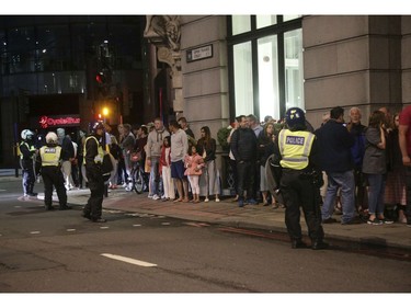 Guests from the Premier Inn Bankside Hotel are evacuated and kept in a group with police on Upper Thames Street.