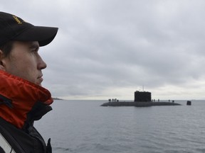 A Maritime Engineering Systems Operator from Her Majesty’s Canadian Ship (HMCS) SASKATOON stands at attention as HMCS Chicoutimi passes on February 20, 2017 as HMCS SASKATOON leaves Esquimalt for Operation CARIBBE. Photo: Royal Canadian Navy.