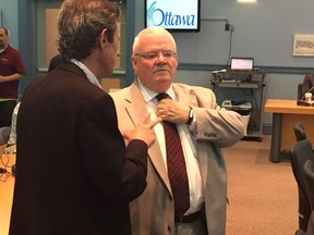 City auditor general Ken Hughes (right) prepares to deliver his latest reports at Ottawa City Hall on Thursday.