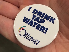 A City of Ottawa button promoting tap water. (Photo by Jon Willing)