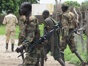 The Streit Group recently unveiled a new armoured vehicle at a defence trade show in London, England. The Canadian firm has been criticized for providing some of its vehicles to South Sudan. This file photo shows heavily armed fighters roaming the streets of Juba, South Sudan during an outbreak of ethnic violence in 2013. Streit Group has stated it follows all international regulations for its vehicle sales. Photo by Nick Coghlan Picasa.