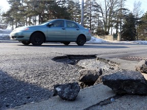 Pothole on Baseline eastbound in February 28, 2017. (Jean Levac, Postmedia)