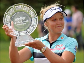 Brooke Henderson, of Canada, poses with the trophy after winning the Meijer LPGA Classic golf tournament at Blythefield Country Club. Sunday, June 18, 2017, in Grand Rapids, Mich.. (Cory Olsen/The Grand Rapids Press via AP) ORG XMIT: MIGRA202

MANDATORY CREDIT
Cory Olsen, AP