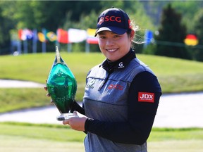 Ariya Jutanugarn of Thailand with the winner's trophy after sinking her birdie putt on the first playoff hole to win the Manulife LPGA Classic on Sunday at Cambridge, Ont.