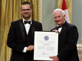 Citizen reporter Matthew Pearson receives the Michener-Deacon Fellowship from Gov. Gen. David Johnston during the Michener Awards at Rideau Hall on Wednesday, June 14, 2017.
