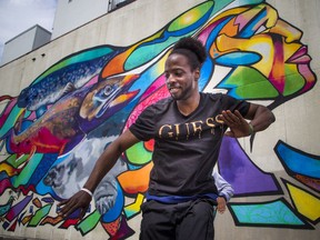 Mozaik, the Vanier block party, shut down part of Montreal Road on Saturday June 10, 2017 to unveil and celebrate Ottawa's tallest mural at 261 Montreal Rd. Duanse Bellot, known as Deec1ple, shows off his moves in front of the giant mural.