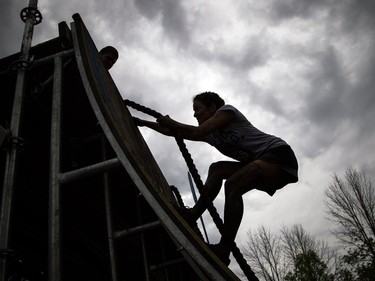 No one was going to finish the Mud Hero obstacles race Sunday June 4, 2017 at Commando Paintball in Navan clean. Nathalie Mimeault makes her way up the rope wall.    Ashley Fraser/Postmedia