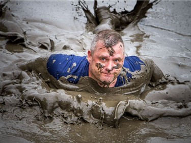 No one was going to finish the Mud Hero obstacles race Sunday June 4, 2017 at Commando Paintball in Navan clean. Rob Sinclair made a splash into the mud at one of the many pits of mud the runners had to make their way through.   Ashley Fraser/Postmedia
