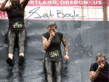 No one was going to finish the Mud Hero obstacles race Sunday June 4, 2017 at Commando Paintball in Navan clean. L-R Sarah Erickson, Olivia Facchin and Susan Philpott go down the huge mud slide.   Ashley Fraser/Postmedia