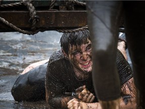 No one was going to finish the Mud Hero obstacles race Sunday June 4, 2017 at Commando Paintball in Navan clean. A young man makes his way through the backwards bullfrog obstacle.   Ashley Fraser/Postmedia