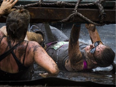 No one was going to finish the Mud Hero obstacles race Sunday June 4, 2017 at Commando Paintball in Navan clean. Sarah Erickson makes her way through the backwards bullfrog obstacle.   Ashley Fraser/Postmedia