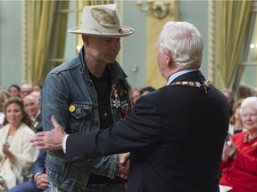 Governor General David Johnston shakes hands with Tragically Hip singer Gord Downie after investing him in the Order of Canada during a ceremony at Rideau Hall, Monday, June 19, 2017 in Ottawa.