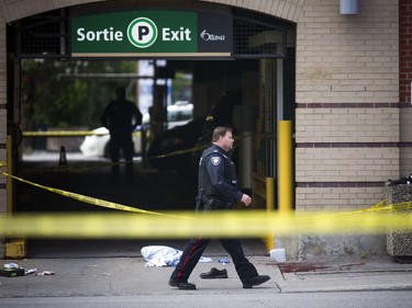 Ottawa Police and the SIU are investigating two fatalities in Ottawa's downtown Saturday June 3, 2017. An Ottawa Police officer in front of a parking garage on Murray street guarding the scene.  Ashley Fraser/Postmedia