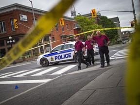 SIU investigators, on scene in downtown Ottawa earlier this month. The agency's updating requires political muscle, writes Tyler Dawson.