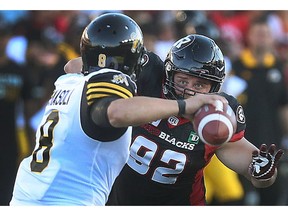 Redblacks defensive tackle Zack Evans pressures Ticats QB during the first half of Thursday's game at TD Place stadium. Tony Caldwell/Postmedia
