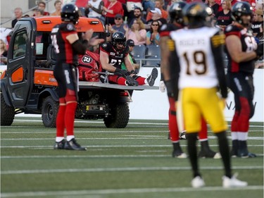 Pierce Burton of the Redblacks rides the cart to the locker room after being hurt on Thursday. Tony Caldwell/Postmedia