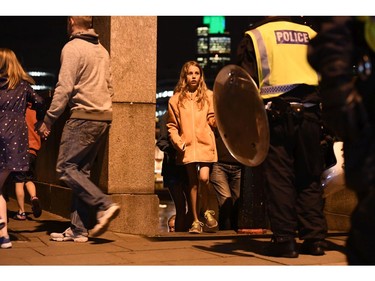 People are led to safety on Southwark Bridge away from London Bridge after an attack.