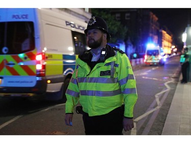 A police officer stands near London Bridge.