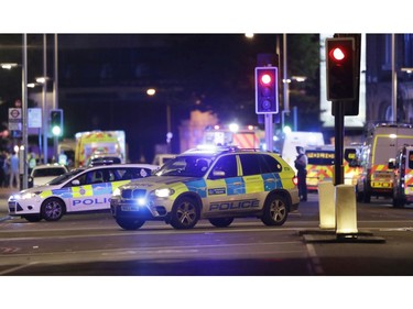 Police cars in the area of London Bridge after an incident in central London, late Saturday, June 3, 2017.  British police said they were dealing with "incidents" on London Bridge and nearby Borough Market in the heart of the British capital Saturday, as witnesses reported a vehicle veering off the road and hitting several pedestrians.