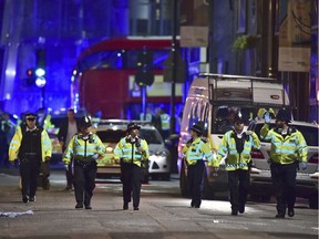 Police officers on Borough High Street as police are dealing with an incident on London Bridge in London, Saturday, June 3, 2017.    Witnesses reported a vehicle hitting pedestrians and injured people on the ground.