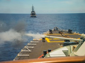 Japanese Ship SAZANAMI sails ahead of HMCS WINNIPEG as she fires her main gun as part of a live fire exercise as part of a multinational training exercise with Japan, Australia, and Canada during POSEIDON CUTLASS on June 9, 2017. Photo: Cpl Carbe Orellana, MARPAC.