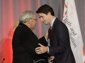 Prime Minister Justin Trudeau (right) greets Justice Murray Sinclair at the release of the Final Report of the Truth and Reconciliation Commission of Canada on the history of Canada's residential school system, in Ottawa on Tuesday, Dec. 15, 2015.