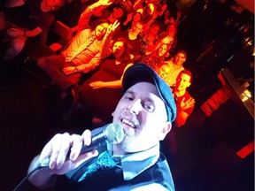 Sam Norton takes a selfie with the phone he used to call Steve Hofstetter who performed his stand-up set over loudspeaker at City At Night on June 18.