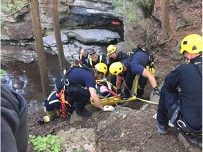 Technical Rescue firefighters raise an injured woman after she fell into a ravine in the Fallingbrook Falls area or Orléans on Saturday. Ottawa Fire Services photo.