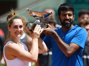 India's Rohan Bopanna and Canada's Gabriela Dabrowski celebrate after winning their mixed doubles tennis match against Colombia's Robert Farah and Germany's Anna-Lena Groenefeld at the Roland Garros 2017 French Open on June 8, 2017 in Paris.