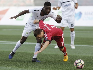 Ottawa's Ryan Williams, right, battles for possession with Harrisburg City's Abass Mohammed.   Patrick Doyle/Postmedia