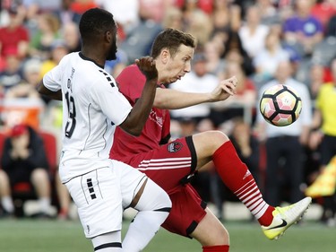 The Islanders' Mike Olla, left, pressures Fury FC's Shane McEleney.