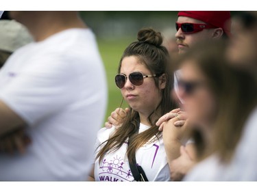 Victoria Hacker who was walking in support of a family friend, stands listening to the speeches prior to the ALS walk Saturday morning.