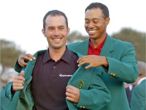 Tiger Woods, right, helps Canadian Mike Weir don the traditional green jacket after the Bright's Grove, Ont. native won the 2003 Masters, at the Augusta National Golf Club in Augusta, Ga., April 13, 2003.
