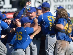 Windsor St Anne Saints spray pitcher Chris Mousseau, centre, with water after striking out the last batter to defeat Ottawa St. Joseph's Jaguars 3-2 to win the OFSSA boys baseball championship at Labatt Park in London, Ontario on Wednesday June 7, 2017.