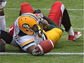 Edmonton Eskimos Travon Van (5) reaches the ball across the goal line to score a touchdown against the Calgary Stampeders during a preseason CFL game at Commonwealth Stadium in Edmonton, June 11, 2017.