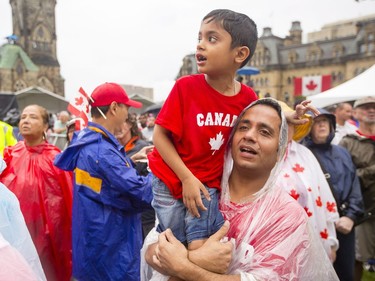 Gourd Sharma holds his son, Ishant, on the front lawn of Parliament Hill during Canada Day celebrations in downtown Ottawa Saturday, July 1, 2017.